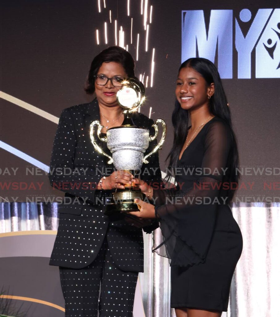 President Christine Kangaloo presents Brianna Harricharan with the sport award for the ages ten-17 category for her outstanding achievements in cricket, tennis and martial arts during the National Youth Awards 2024. Harricharan also won the youth of the year award for the same age category. The National Youth Awards were hosted by the Ministry of Youth Development and National Service's at Hyatt Regency on September 19. - - Photo by Roger Jacob