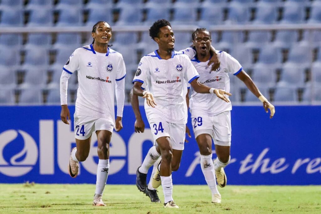 Miscellaneous Police FC forward Ezekiel Kesar (C) celebrates his winning goal during the Concacaf Caribbean Cup group A match versus Arnett Gardens at the Hasely Crawford Stadium, Mucurapo on September 19, 2024. - 