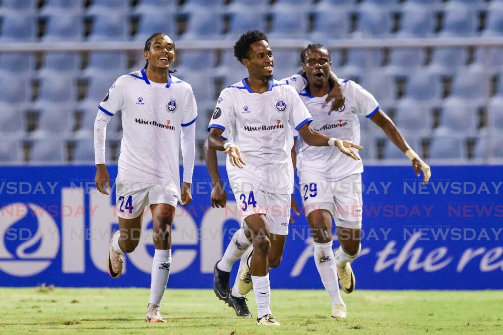 Miscellaneous Police FC forward Ezekiel Kesar (C) celebrates his winning goal during the Concacaf Caribbean Cup Group A match versus Arnett Gardens at the Hasely Crawford Stadium, Mucurapo on September 19. Photo courtesy Daniel Prentice.  - 