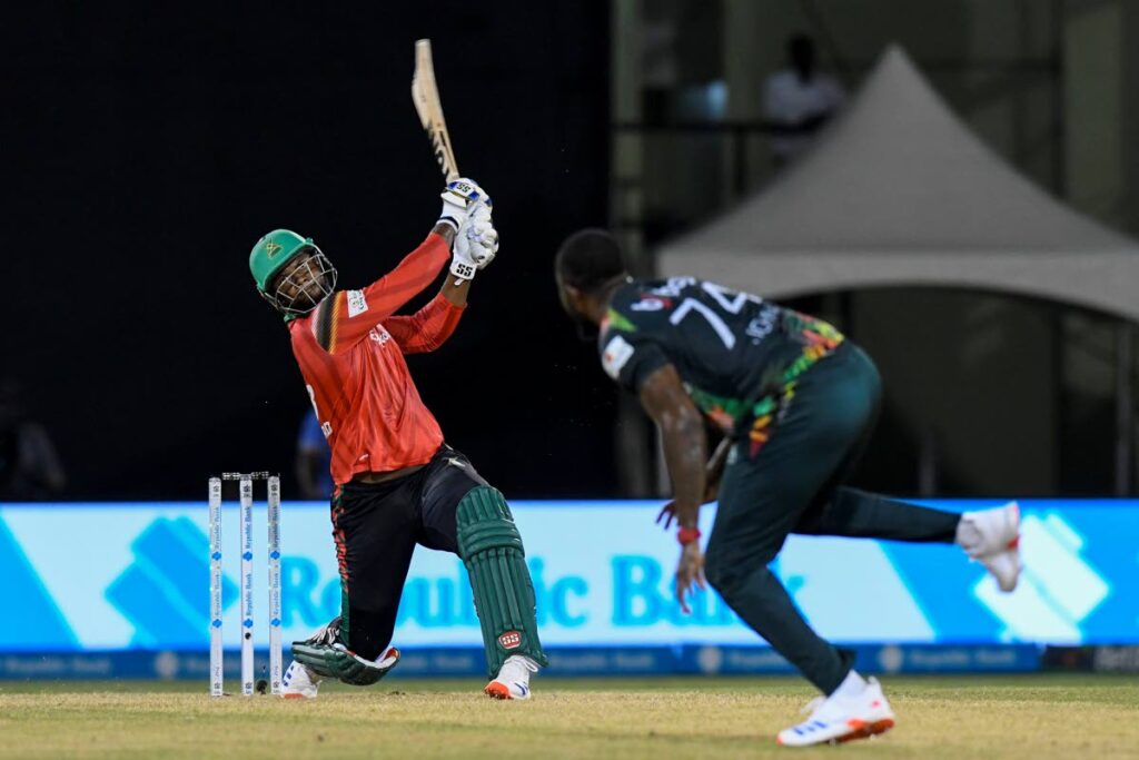 Guyana Amazon Warriors allrounder Romario Shepherd (left) hits Ryan John for a six during the 2024 Republic Bank CPL clash with St Kitts and Nevis Patriots at Providence Stadium in Guyana on September 20, 2024. - Photo courtesy CPL T20 