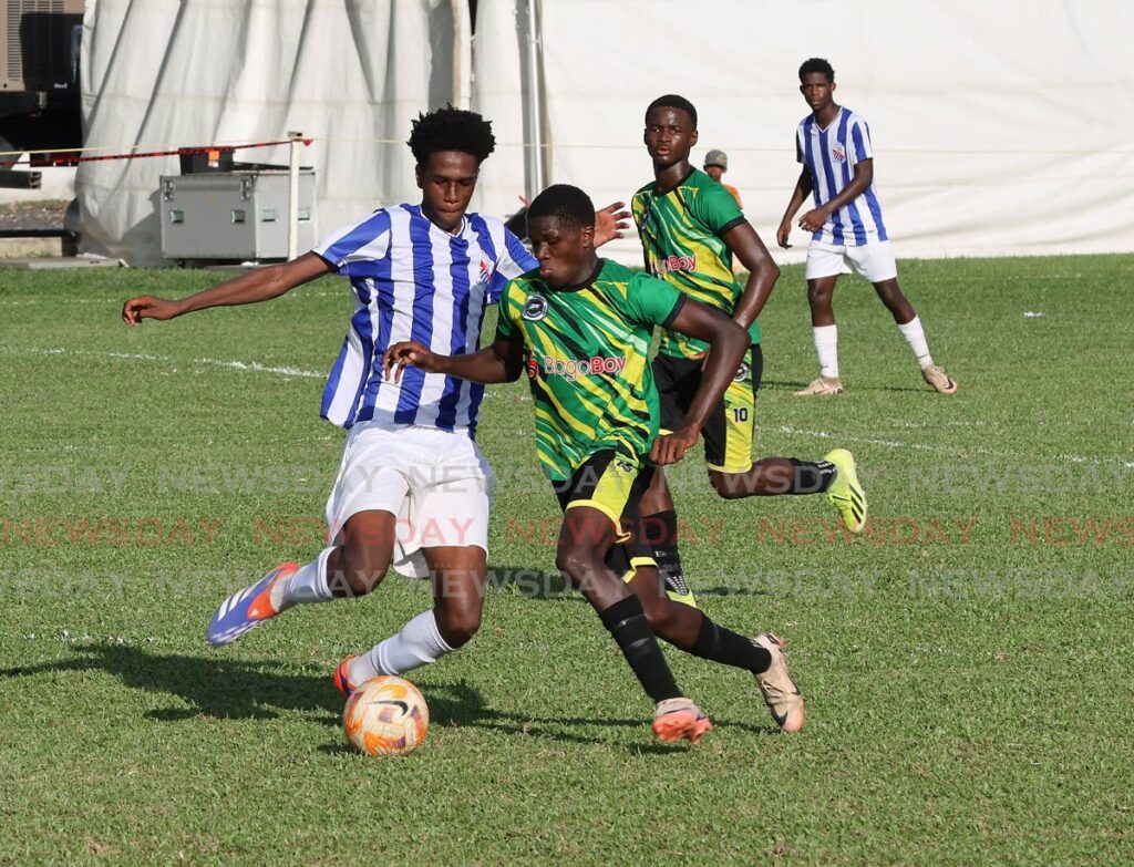 St Mary’s College’s Kristian James (L) and Signal Hill Secondary’s Khaleem Trim vie for possession during the SSFL premiership match, on September 21, at the St Mary’s College Grounds, St Clair.  - Photo by Roger Jacob 