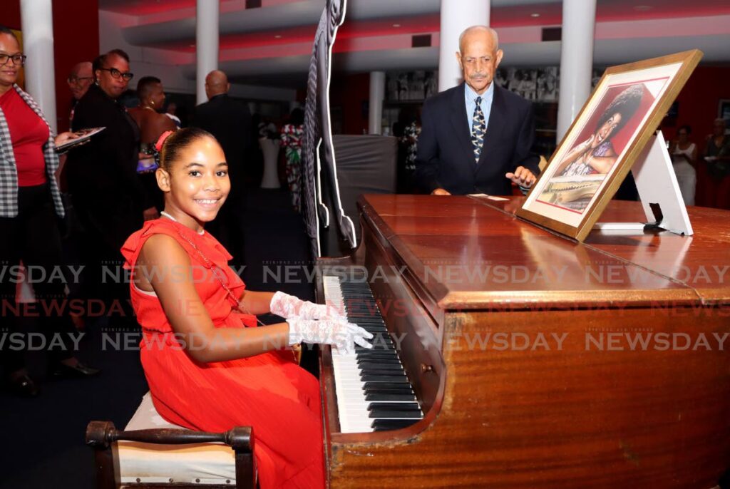 Little Sophia Thomas, ten, plays the piano once owned by her relative, legendary pianist Winifred Atwell, during the renaming ceremony on September 23 of the Queen's Hall auditorium to the Winifred Atwell Auditorium. - AYANNA KINSALE