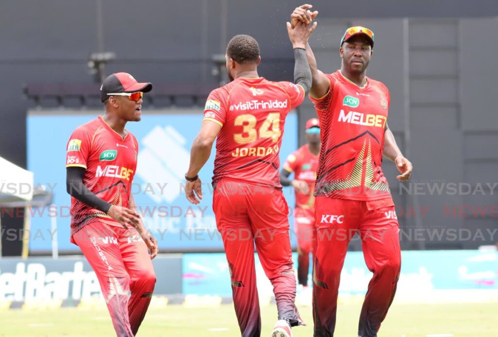 (L-R) Trinbago Knight Riders’ Akeal Hosein. Christopher Jordan, and Andre Russell celebrate a wicket against the St Lucia Kings during the Republic Bank Caribbean Premier League match at the Brian Lara Cricket Academy, Tarouba, on September 24, 2024. - Photo by Ayanna Kinsale 