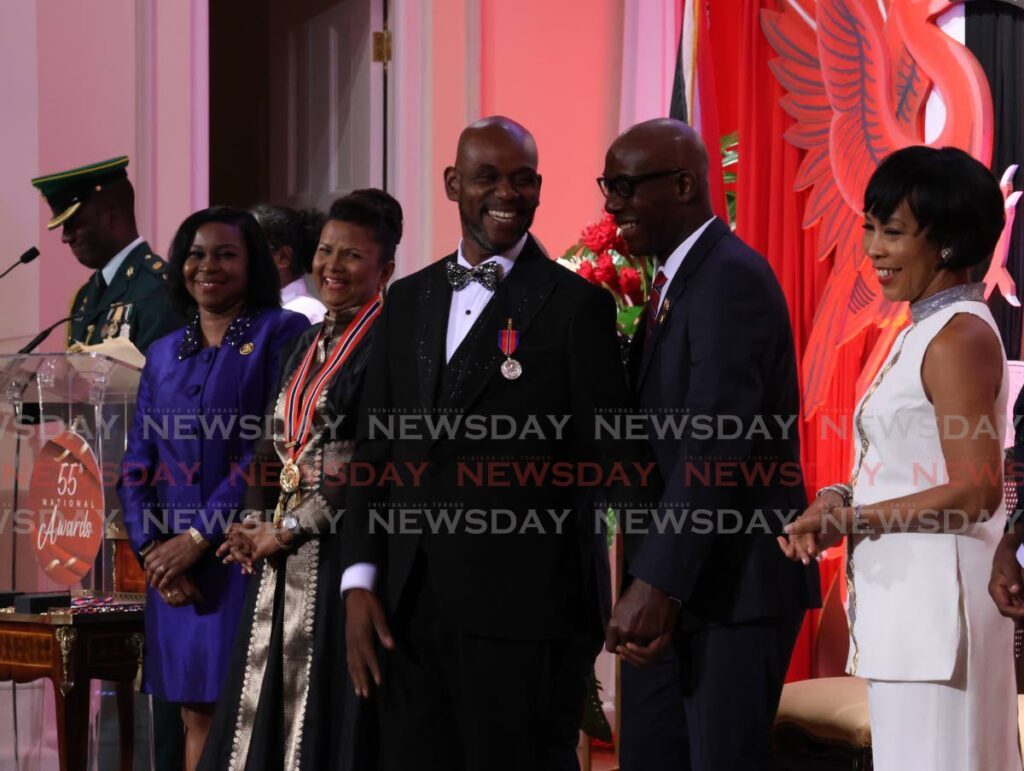 WHERE PAN HAS TAKEN DUVONE: Pan arranger and teacher Duvone Stewart jokes with Prime Minister Dr Keith Rowley, 2nd from right, after receiving the Humming Bird (Silver) at the National Awards, President's House on Republic Day. PHOTO BY ROGER JACOB - 