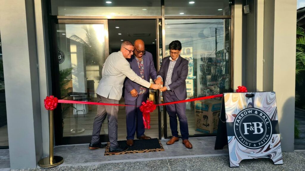 President of the Greater San Fernando Area Chamber of Commerce Kiran Singh, left and councillor Ryaad Hosein, right, join Caribbean Coatings CEO, Michael Dingwell in cutting the ribbon to open Farrow & Ball on at Drayton Street, San Fernando.
 - 