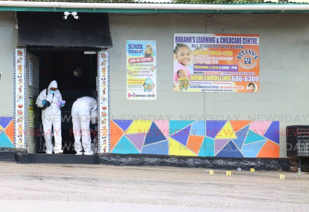 Crime scene officers at the entrance to Roxann's Learning and Childhood Centre in Malick on September 25 after the deadly gunplay. - Photo by Faith Ayoung