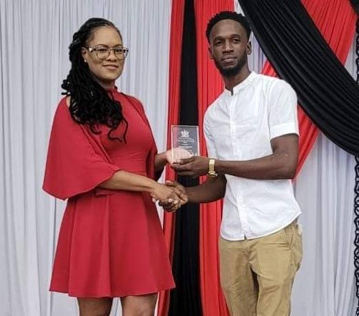 Minister in the Office of the Prime Minister Ayanna Webster-Roy, left, presents the Minister's Spirited Award to Jimmel Morton, at the Republic Day Awards, Delaford Community Centre, on September 24.  - 