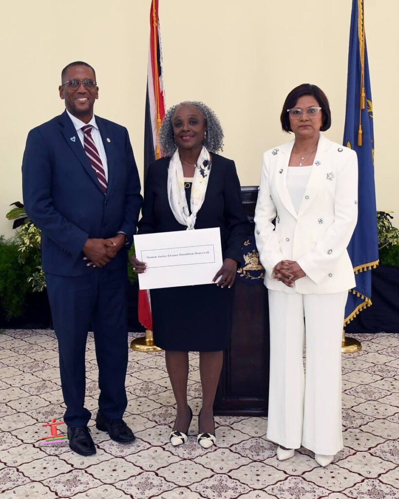 Newly-appointed Justice of Appeal Eleanor Joy Donaldson-Honeywell, centre, receives her instrument of appointment from President Christine Kangaloo and Chief Justice Ivor Archie on September 27 at the Office of the President. - Photo courtesy Office of the President.