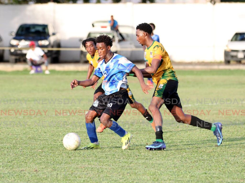 Malick Secondary School Tyrese Manswell (C) gains control of the ball against St Benedicts College during the Secondary School Football premiership division match at St Mary’s Ground, St Clair, on September 28, 2024. St Benedict’s won 2-1. - Photo by Ayanna Kinsale 