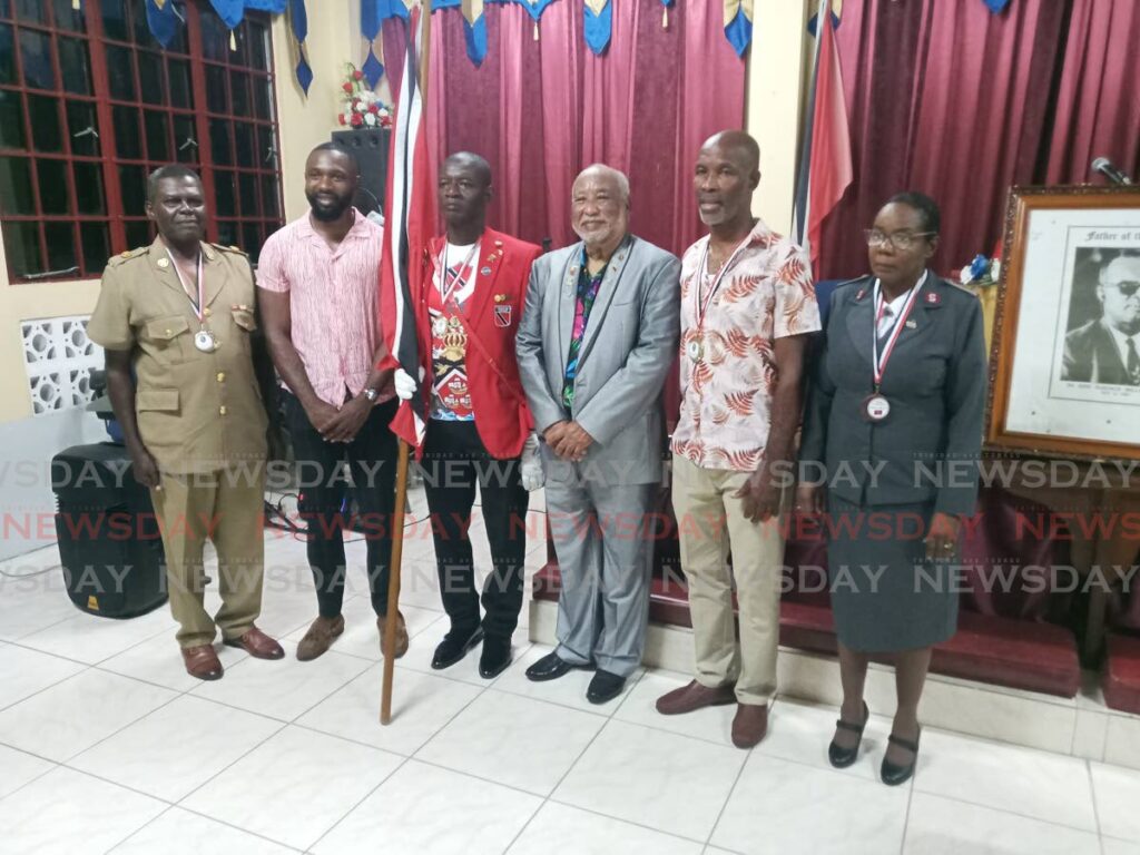 HONOURING SERVICE: From left, Major Alexander Thomas, battallion commander, Tobago Cadet Force; THA Minority Leader Kelvon Morris; national flag-bearer David Nelson; chairman of the Dr Eric Williams memorial Committee Reginald Vidale; NLCB Buccooneers captain Anthony Hopkins; and Ushabelle Jarvis, administrator the Salvation Army’s Josephine Shaw House.  - Photo by Corey Connelly