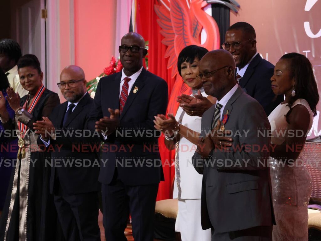 Stanford Callender, right, former PNM Tobago West MP, after receiving the Hummingbird Medal Gold for his contribution to community and public service at the Republic Day National Awards ceremony at President's House, Port of Spain, on September 24. - Photo by Roger Jacob