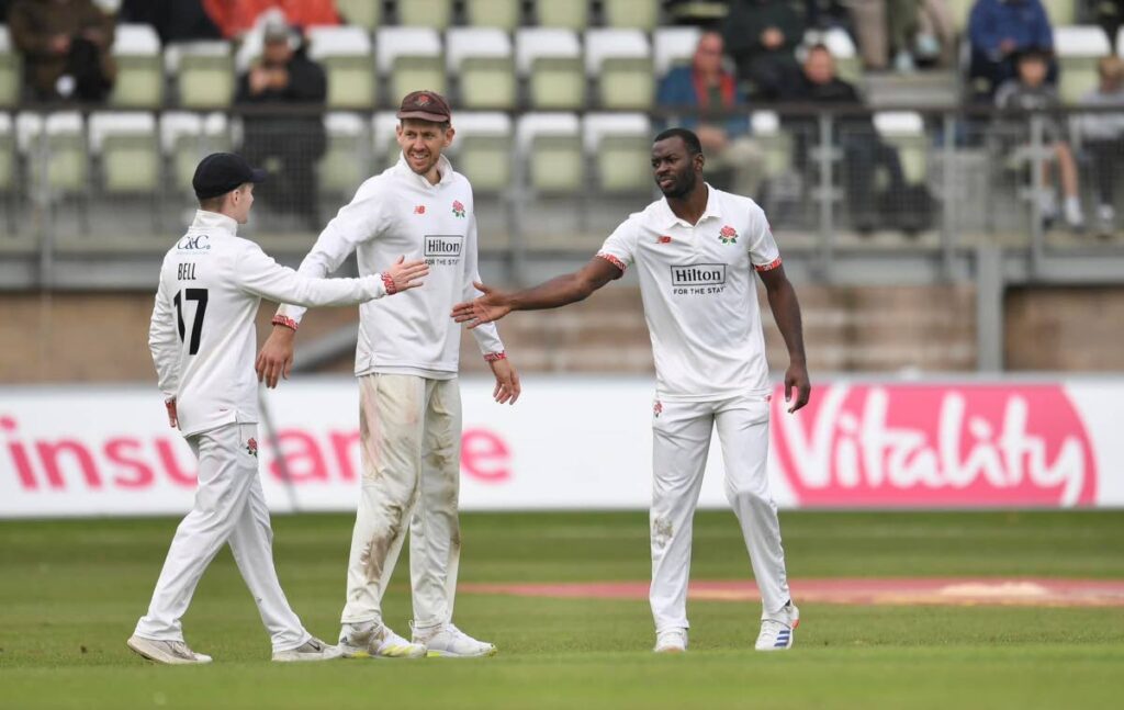 TT fastbowler Anderson Phillip (right) is congratulated by his Lancashire teammate George Bell (left) during their English County Championship Division one match against Worcestershire at New Road, Worcester. Photo courtesy Lancashire Cricket.  - 