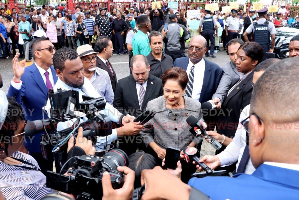 Opposition Leader Kamla Persad-Bissessar, centre, speaks with the media on arrival at the Red House on September 30.  - Photo by Ayanna Kinsale