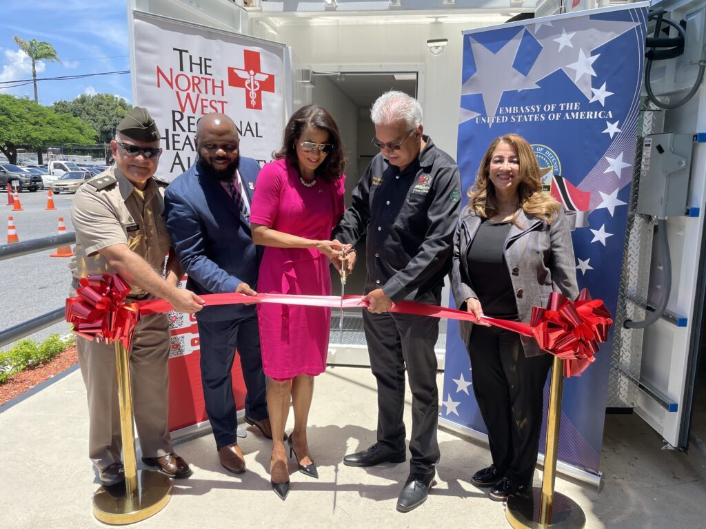 From left, US Southern Command deputy commander for mobilisation and reserve affairs Major General Javier Reina, CEO of the North West Regional Health Authority (NWRHA) Major (Ret) Anthony Blake, United States Ambassador to TT Candace Bond, Minister of Health Terrence Deyalsingh, and NWRHA chairman Lisa Agard cut the ribbon to the mobile medical units, Clinics in a Can, on September 18 at the Port of Spain General Hospital. - Photo courtesy the US Embassy