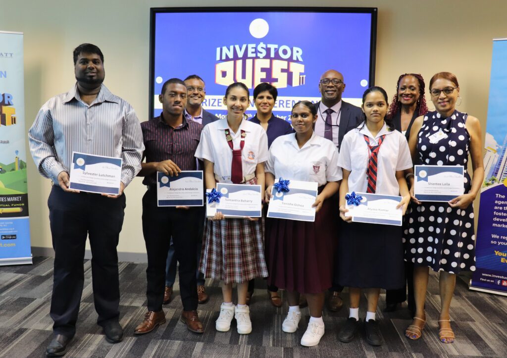 Front row, from left, Sylvester Lutchman, Alejandro Andalcio, Samantha Beharry, Tenisha Ochoa, Alyssa Kumar and Shantee Lalla. Back row, from left, UTT lecturer Dinesh Soodeen, UTT member Donica Mahabir, TT Securities and Exchange Commission CEO Kester Guy and the exchange's manager of corporate communications Ellen Lewis. - Photo courtesy TTSEC