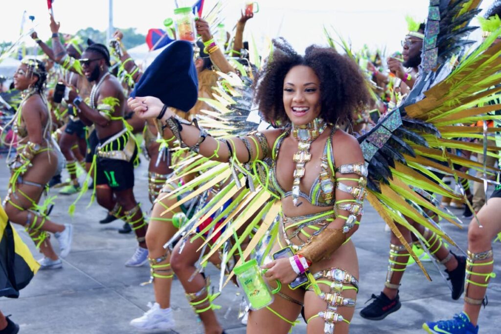 Masqueraders have fun at Miami Carnival parade of bands. - 