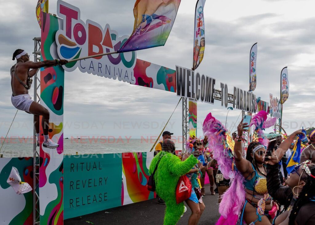 Masqueraders enjoy themselves on the stage in the sea during the parade of the bands, on the final day of Tobago Carnival in 2022. - File photo