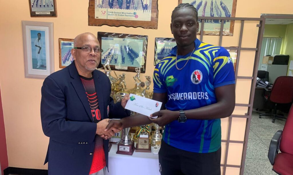 TT Cricket Board president Azim Bassarath, left, presents an award to cricketer Joshua James. - File photo