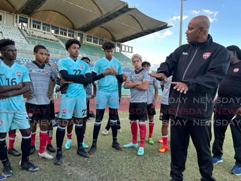 In this file photo TT men’s U17 head coach Shawn Cooper speaks with members of the team, at the Manny Ramjohn Stadium. - David Scarlett