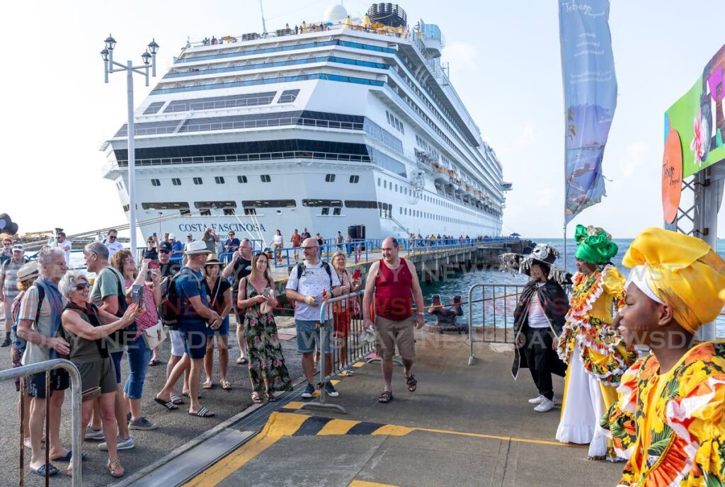 Visitors, many from Italy, arriving on the Costa Fascinosa enjoy a welcome by traditional characters at Scarborough, Tobago in 2023. - File photo