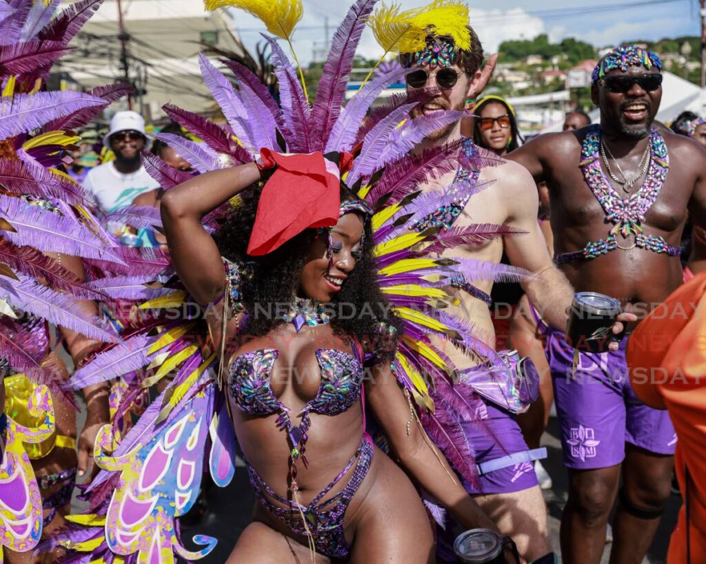 Masqueraders from the band Zain Carnival Experience enjoy the parade of the bands on Milford Road, Scarborough during Tobago carnival 2023. - FILE PHOTO