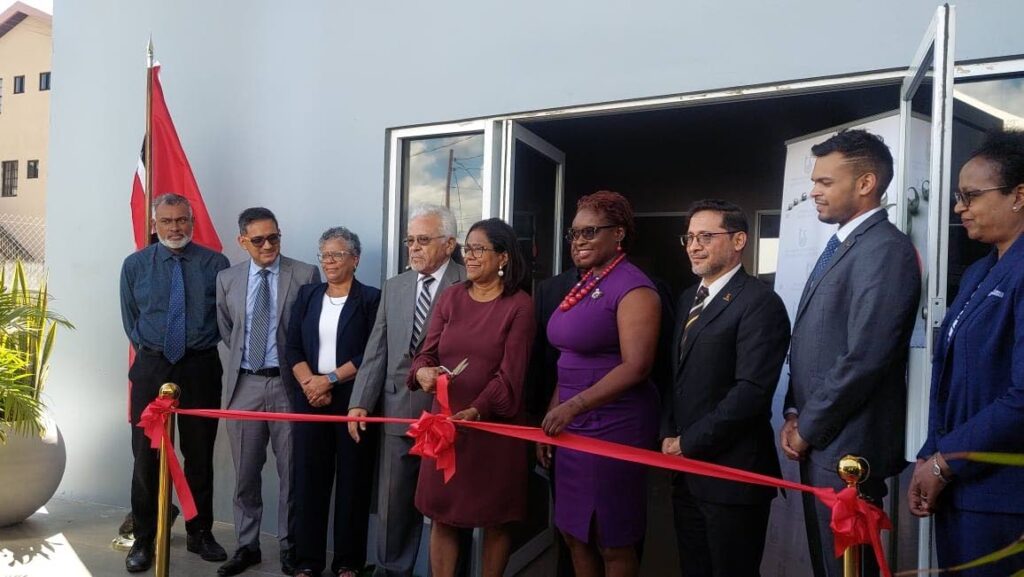 Trade and Industry Ministry Paula Gopee-Scoon cuts the ribbon to open the TT Bureau of Standards sub-office in Crown Point, Tobago. Also present are Deputy Chief Secretary Dr Faith BYisrael, fourth from left, and other officials.  - 