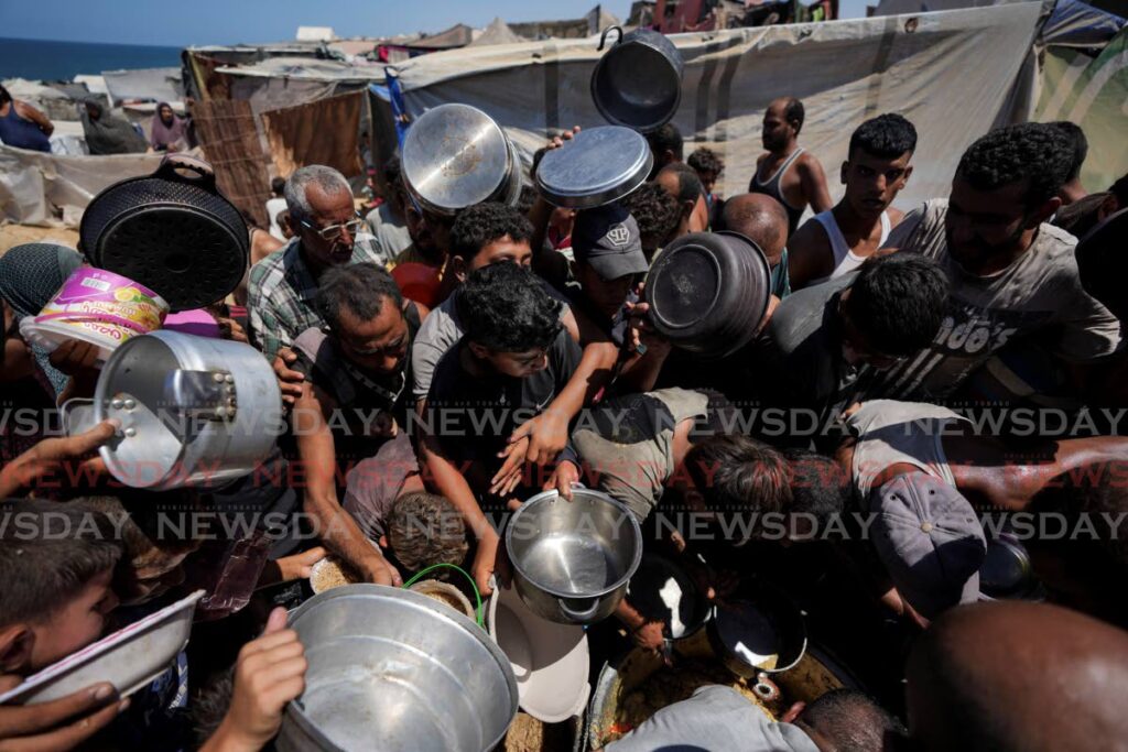 Displaced Palestinians at a food distribution centre in Deir al Balah, central Gaza Strip. AP PHOTO - 