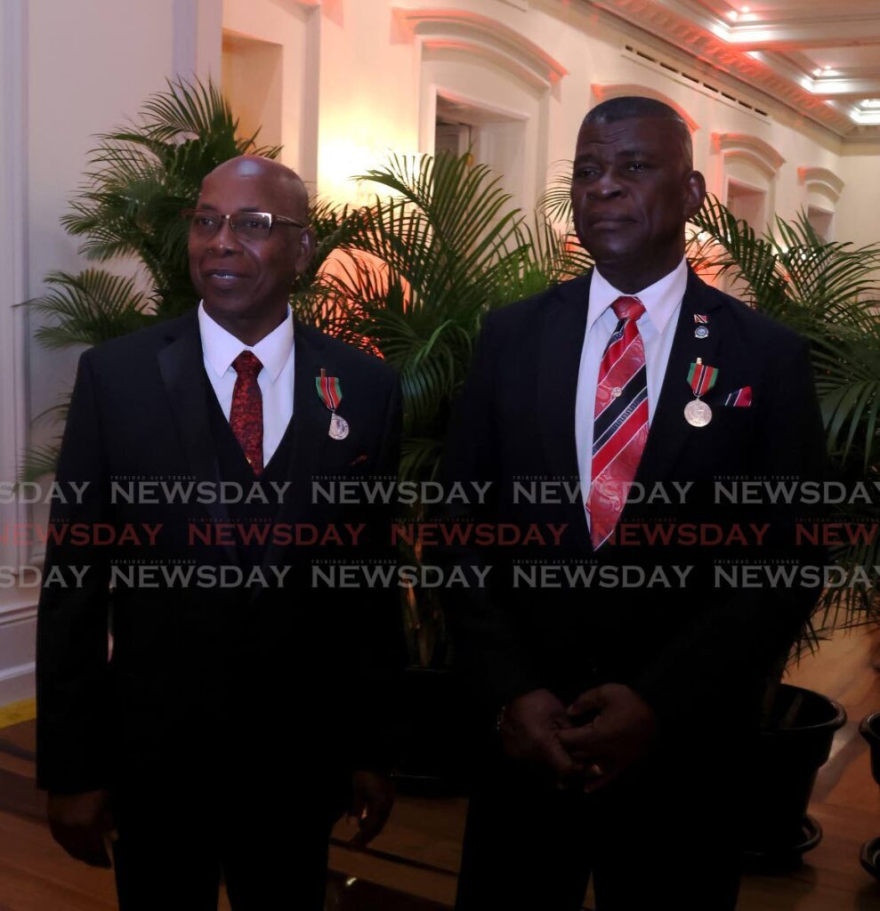 Former acting commissioners of police James Philbert and Stephen Williams after receiving their national awards on Republic Day. - ROGER JACOB