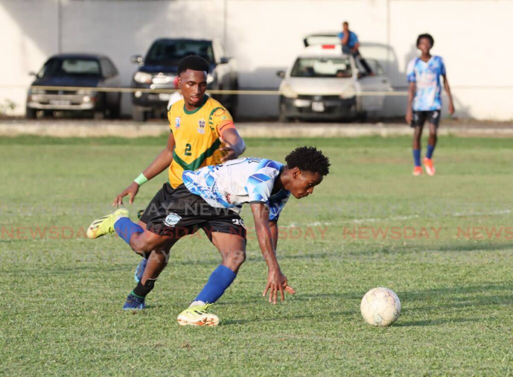 St Benedicts College Ackeem James, left, and Malick Secondary School Tyrese Manswell go after the ball during the Secondary School Football Premiership Division at St Mary's Ground, St Clair. on September 28,2024. - AYANNA KINSALE