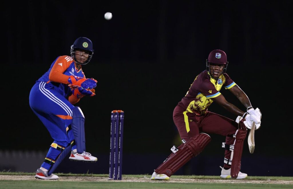 West Indies women's allrounder Chinelle Henry cuts the ball towards the boundary as India's wicket-keeper Richa Ghosh looks on during an ICC T20 Women's World Cup warm-up match at the ICC Academy Ground, Dubai on September 29. Photo courtesy Matthew Lewis-ICC/ICC via Getty Images) - 