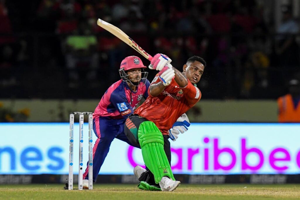 Guyana Amazon Warriors’  Shimron Hetmyer hits  a six as Quinton de Kock (L) of Barbados Royals watches during the 2024 Republic Bank Caribbean Premier League match 27 at Guyana National Stadium on September 25, 2024 in Providence, Guyana. - ( CPL T20)