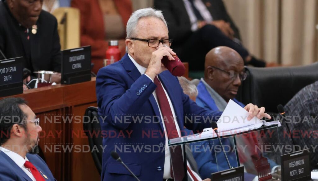 Finance Minister Colm Imbert pauses to drink water during his budget on September 30 in the House of Representatives. - Photo by Roger Jacob