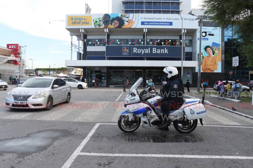 PC Ramsaroop keeps a close-eye on the public on Independence Square, Port of Spain on September 30. Finance Minister Colm Imbert announced a plan to buy 2,000 new police cars over the next three years.  - Photo by Faith Ayoung