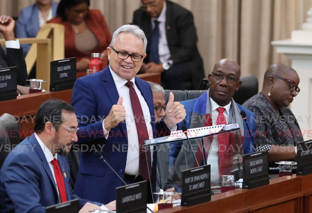 BUDGET PRIDE: Finance Minister Colm Imbert, flanked by Energy Minister Stuart Young and the Prime Minister, delivers the 2024/2025 budget in Parliament on September 30. - Photo by Roger Jacob 