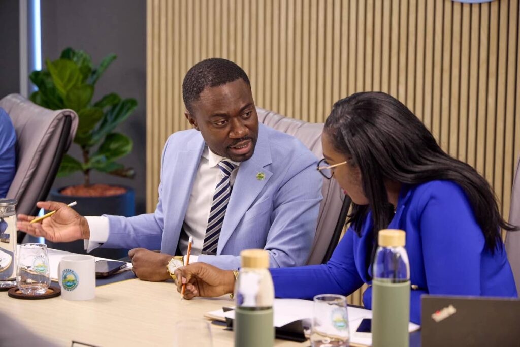 THA Chief Secretary Farley Augustine, left, and Secretary of Finance Petal-Ann Roberts chat while viewing the national budget presentation in Tobago. - THA