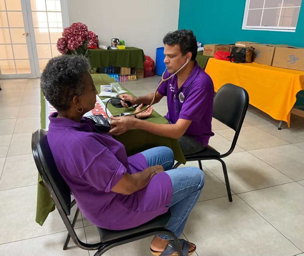 A member of the Geriatric Society gets a free health check up from Dr Sambhasivan Kattamanchi. - 