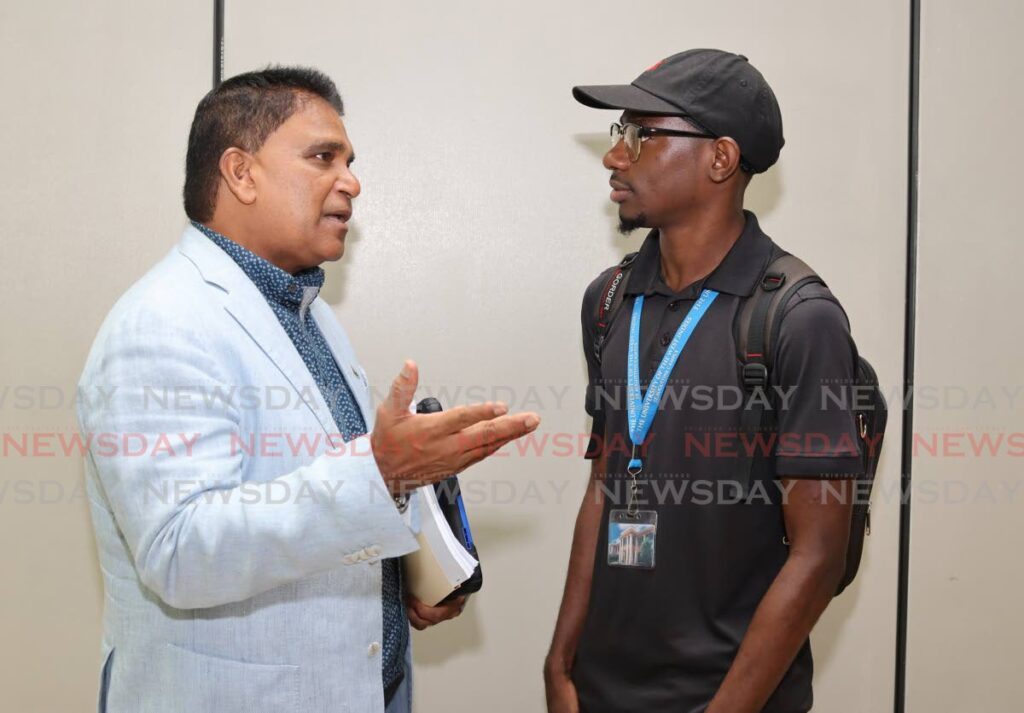 Opposition MP Dr Roodal Moonilal speaks to Isaiah Labadie, a UWI student after a guest lecture on policy analysis at UWI St Augustine on October 1.  - Photo by Gabriel Williams