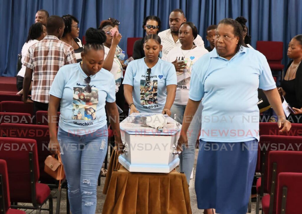 Abeke Jones, left, and other relatives carry the casket bearing the body of Jones's son Kaden Sandy out of the Shiloh SDA Church on Lady Young Road, Morvant, on October 1. 
Sandy, eight, died in a boating accident at sea on September 22. 
 - Roger Jacob