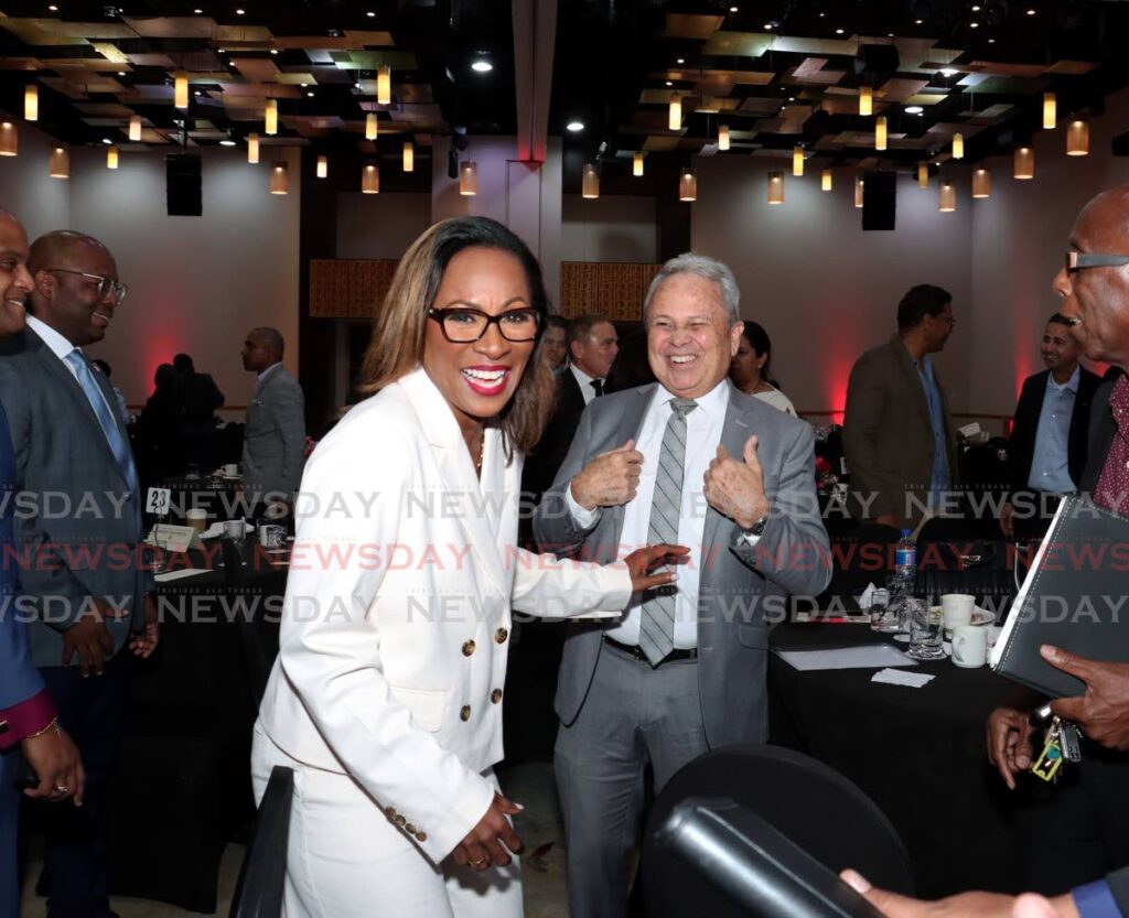 MAN OF THE HOUR: Economist Dr Marlene Attzs shares a light moment with Finance Minister Colm Imbert at the TT Manufacturers' Association post-budget discussion at the Hyatt Regency, Port of Spain on October 1.  - Faith Ayoung