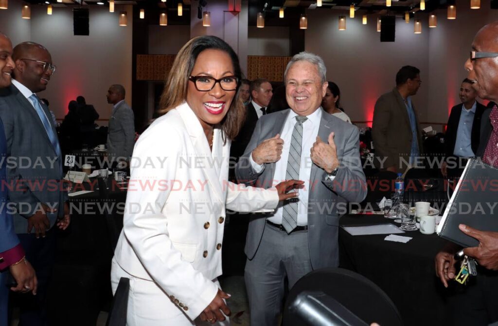 MAN OF THE HOUR: Economist Dr Marlene Attzs shares a light moment with Finance Minister Colm Imbert at the TT Manufacturers' Association post-budget discussion at the Hyatt Regency, Port of Spain on October 1.  - Photo by Faith Ayoung