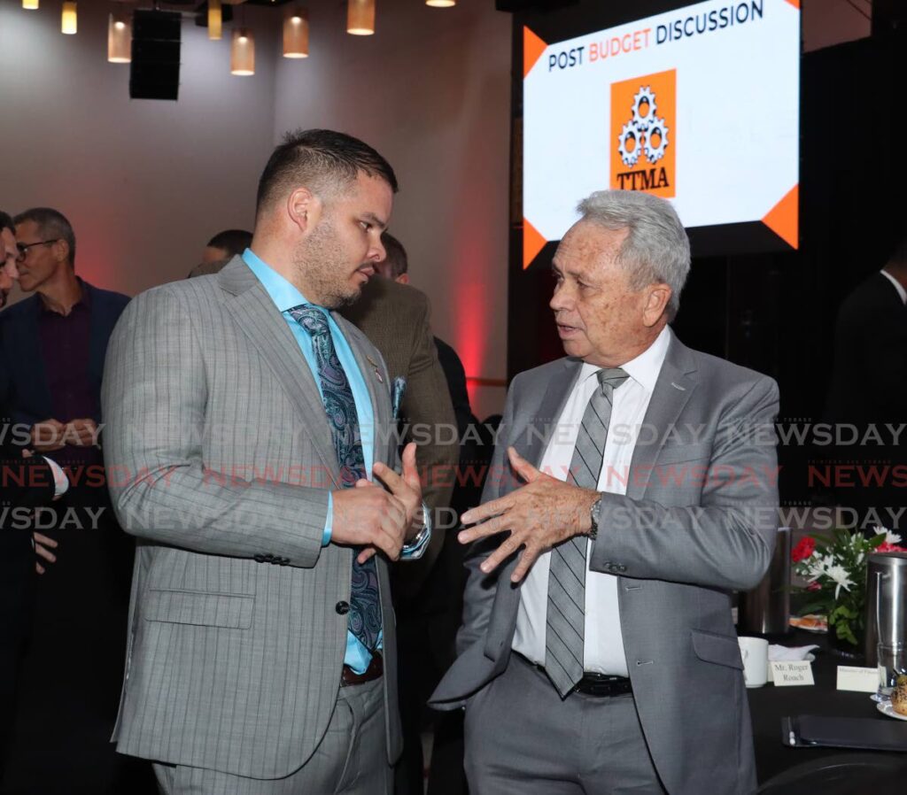 Imbert talks business: Jonathan Garcia, managing director of Crystal Ltd, left, speaks with Finance Minister Colm Imbert at the TTMA's post-budget discussion at Hyatt Regency, Port of Spain on October 1.  - Photo by Faith Ayoung