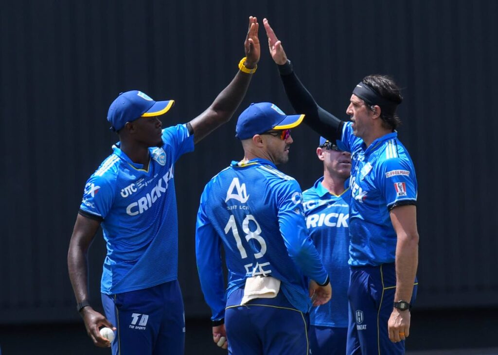 Alzarri Joseph (L), David Wiese (R) and Faf Du Plessis (C) of Saint Lucia Kings celebrate the dismissal of Rahmanullah Gurbaz of Guyana Amazon Warriors during the Men’s 2024 Republic Bank Caribbean Premier League match 29 at Guyana National Stadium on September 28, 2024 in Providence, Guyana. - (CPL T20)