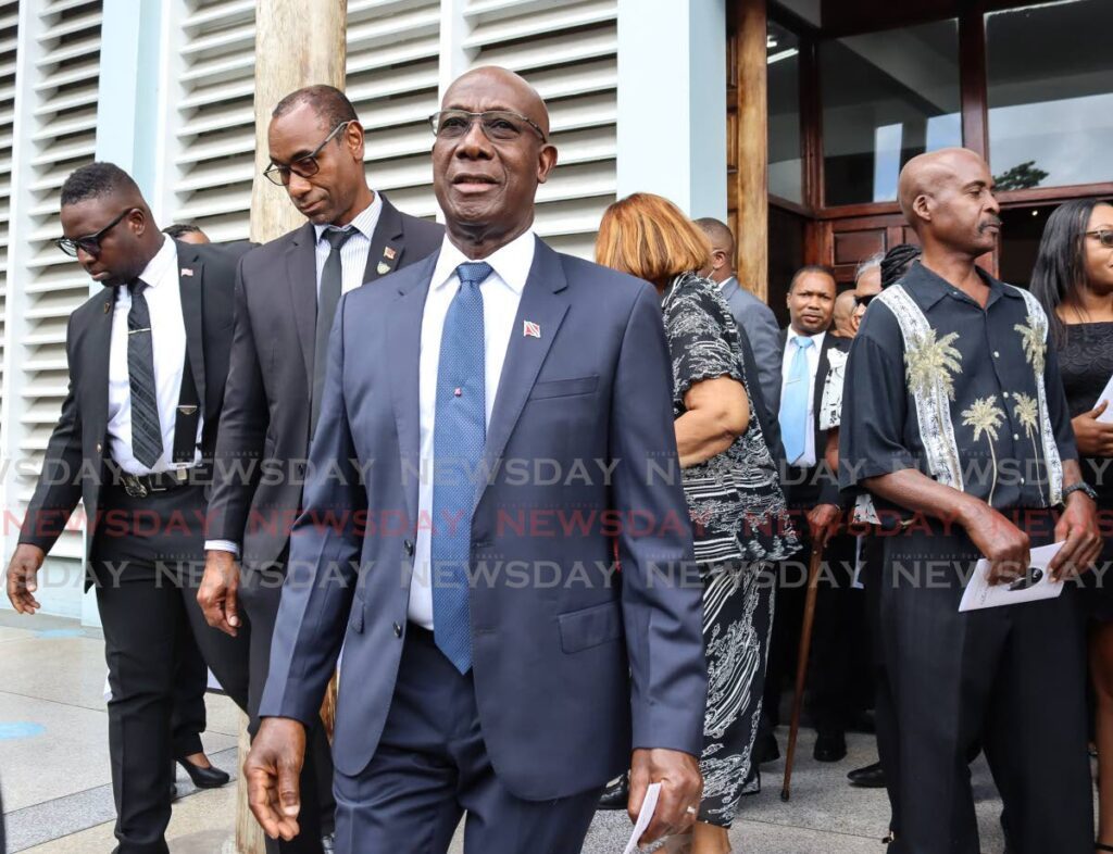 Prime Minister Dr Keith Rowley leaves the funeral of former Port of Spain mayor, Ethelbert 