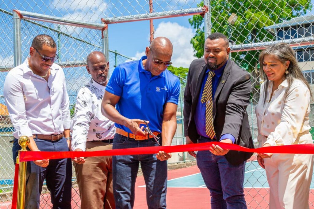 Darryl White, CEO of RBC Financial Caribbean Ltd, an alumnus of Presentation College, centre, cuts the ribbon to officially open the refurbished tennis courts. From left: Ainsley Welch, chairman, PREStige; Dexter Mitchell, principal, Presentation College; Jason Daily, president, Past Students Association; Simone Edwards, vice president, personal banking and head of the RBC Education Foundation.  - 