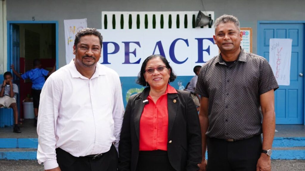 Alderman Irene Medina, centre, joins principal of Arima Boys RC School Navin Harry and vice principal Justin Jagan at the Peace of Power event on September 30. - 