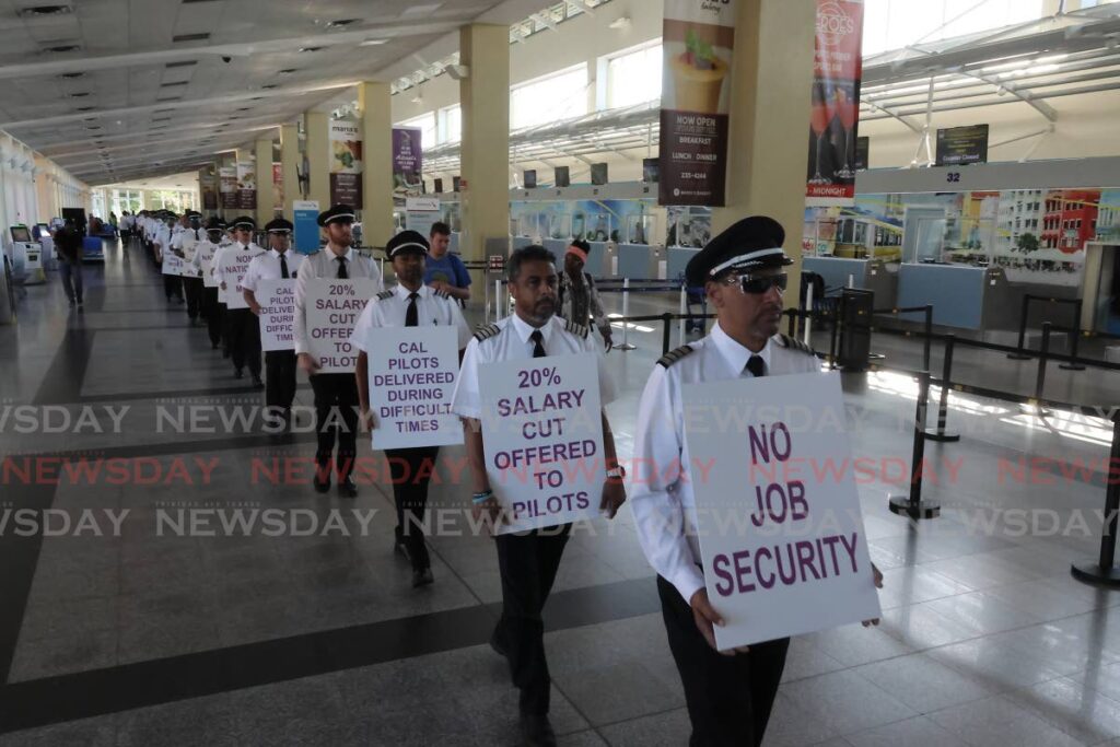 Caribbean Airlines pilots, who are members of the TT Airline Pilots Association (TTALPA), protest at Piarco International Airport on October 3 over outstanding wage negotiations.  - FILE PHOTO 