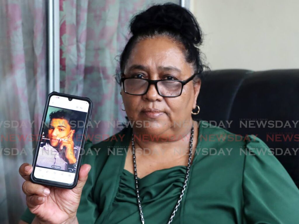 SON WHERE ARE YOU?: Lyncia Hansranah shows her cellphone which has on its screen, a photo of her kidnapped son Sachel Kungebeharry, during an interview on Thursday at her Cunupia home. PHOTO BY AYANNA KINSALE  - AYANNA KINSALE