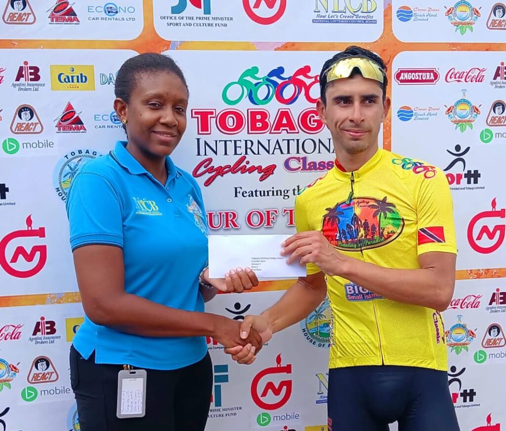 Mexican cyclist Eder Freyre collects one of his prizes from Ashanti Jack, acting supervisor NLCB Tobago, after winning stage two of the Tobago International Cycling Classic on October 3. - 