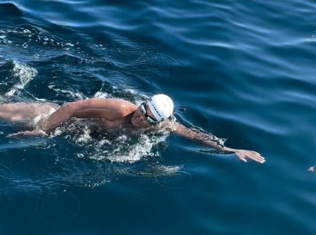 John Procope in the water swimming from Tobago to Trinidad. -