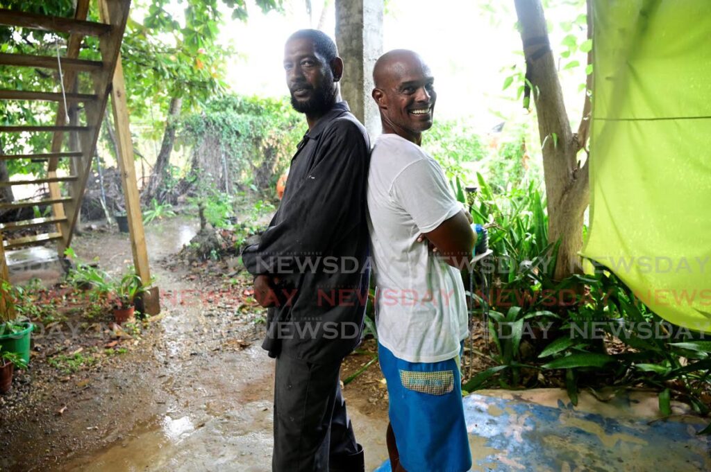 John Procope, right, and a crew member who assisted in his swim from Tobago to Trnidad.  - Photo by Visual Styles